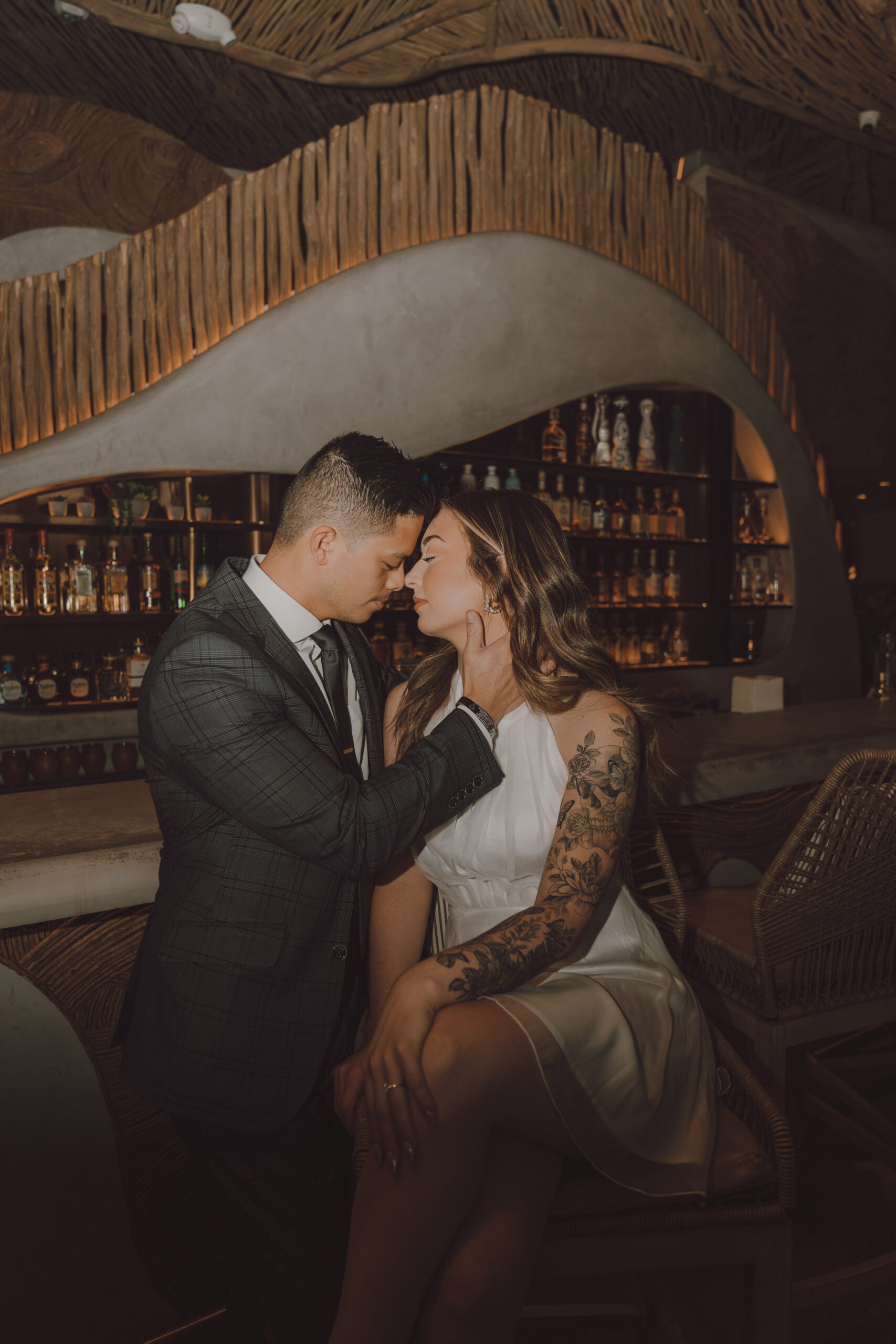 Engaged couple sitting at a bar dressed formally